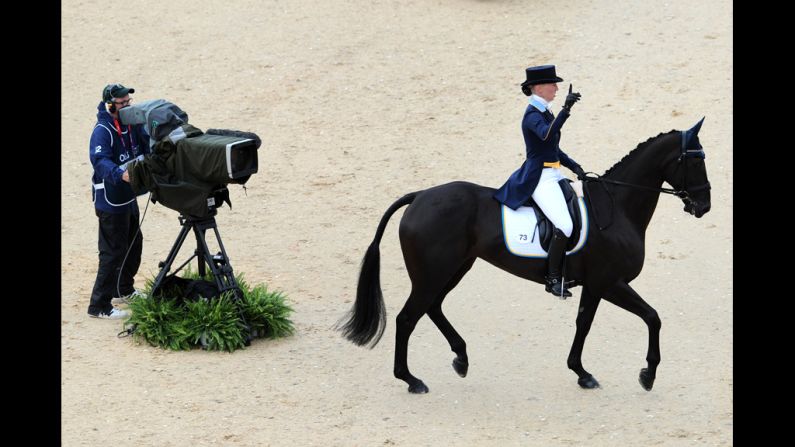 Sweden's Malin Petersen on Sofarsogood acknowledges the crowd after competing in the dressage event.