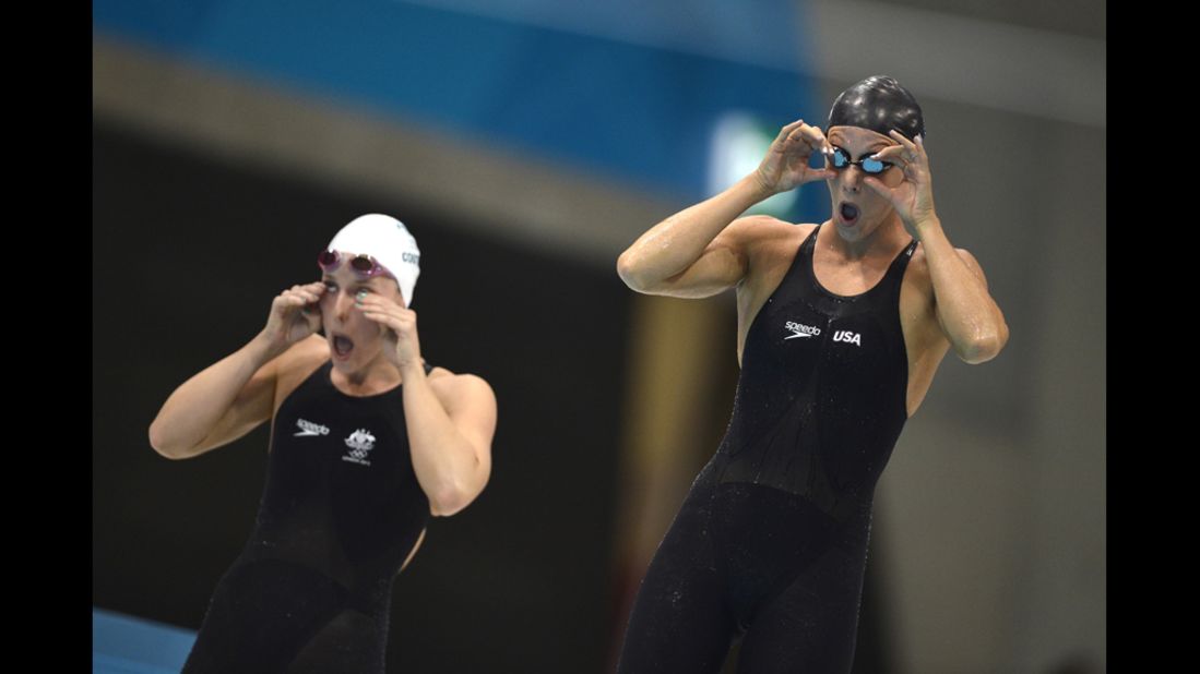 U.S. swimmer Dana Vollmer, right, prepares for the women's 100-meter butterfly final. Vollmer went on to win a gold medal and set a world record in the event, becoming the first woman to go under 56 seconds.