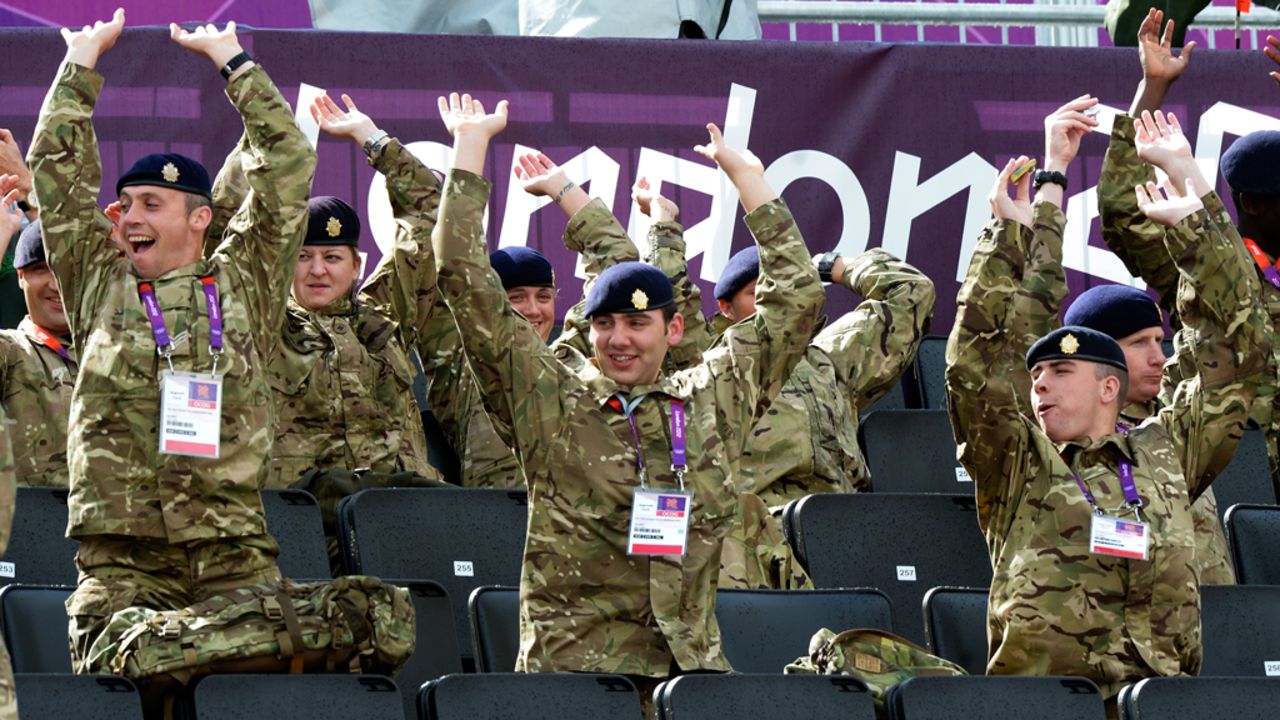 Ignoring both protocol and good sense, British soldiers perform the wave. They are currently imprisoned in the Tower of London and will be beheaded at dawn.