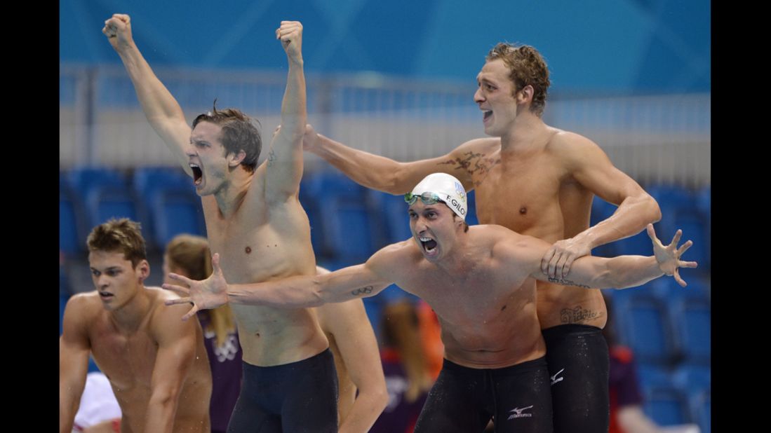 France's Clement Lefert (standing, from left), Amaury Leveaux and Fabien Gilot celebrate after winning the men's 4 x 100-meter freestyle relay final.