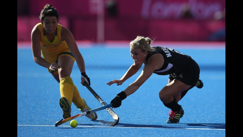 Australia's Jade Close, left, and New Zealand's Emily Naylor, right, compete in field hockey.