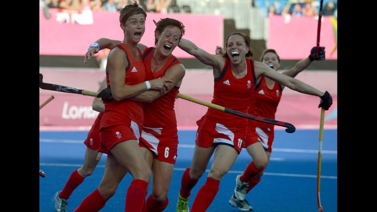 Britain's Sally Watson, left, is congratulated by teammates after scoring against Japan during the women's field hockey preliminary match.