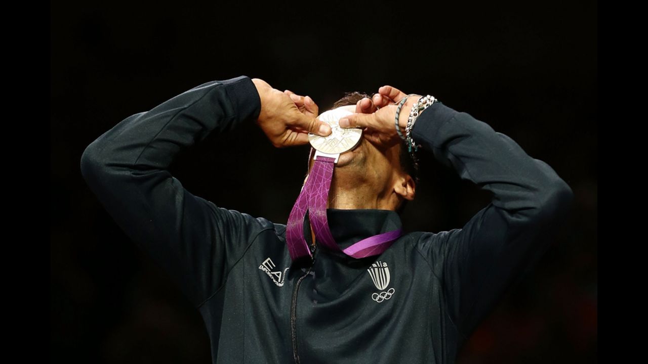 Italian fencer Diego Occhiuzzi kisses his silver medal after the men's individual saber.