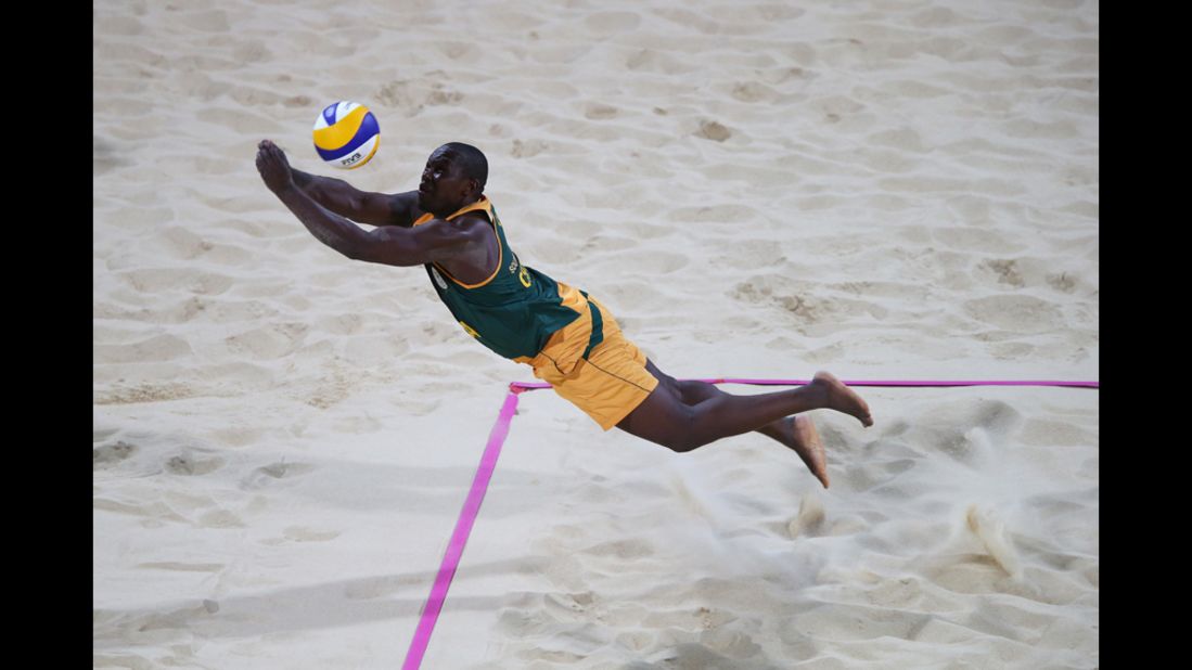 Freedom Chiya of South Africa dives for the ball against the United States during the men's beach volleyball preliminary round.