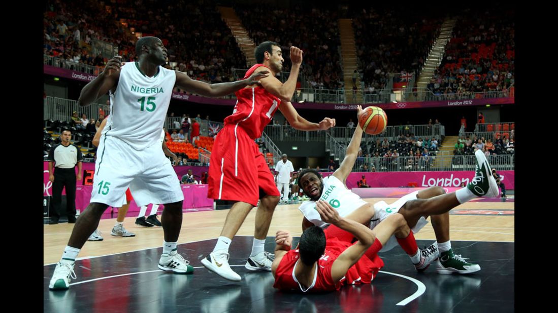 Nigeria's Ike Diogu, No. 6 in white, collides with Tunisia's Salah Mejri, No. 15 in red, during their men's basketball game.