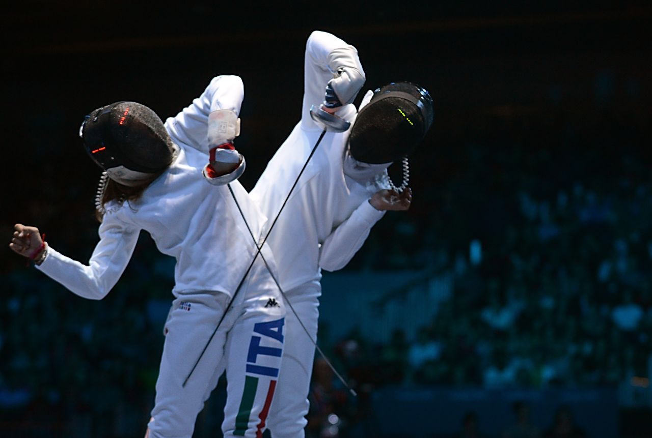 Italy's Rossella Fiamingo, left, faces off against Japan's Nakano Nozomi during the women's epee fencing match Monday. 