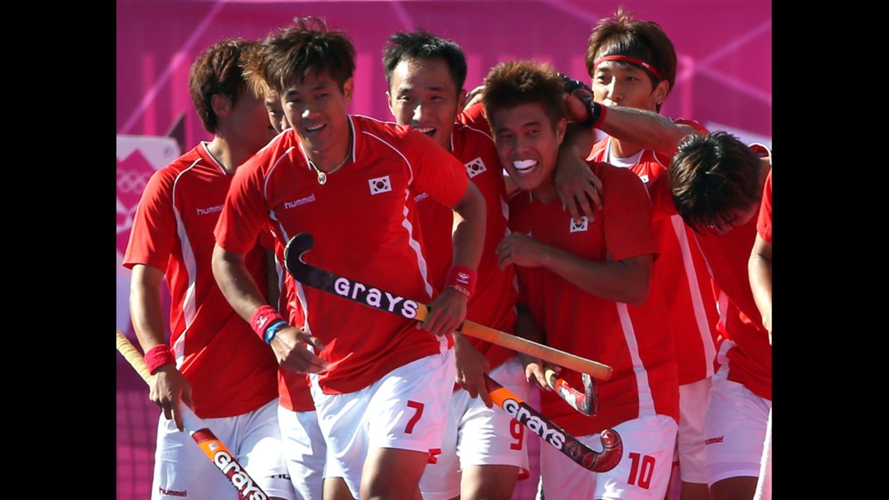 The South Korea men's field hockey team celebrates after scoring a goal against New Zealand during a preliminary match Monday.