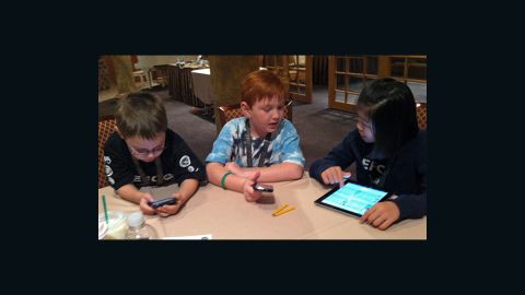Kids learn how to search for vulnerabilities in mobile games at Def Con 20 in Las Vegas.