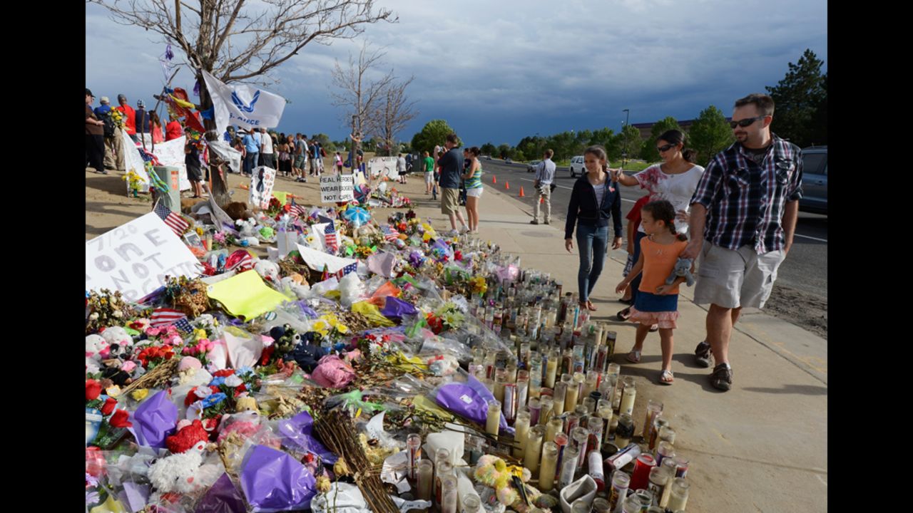 People visit the roadside memorial set up for victims of the massacre on Monday.