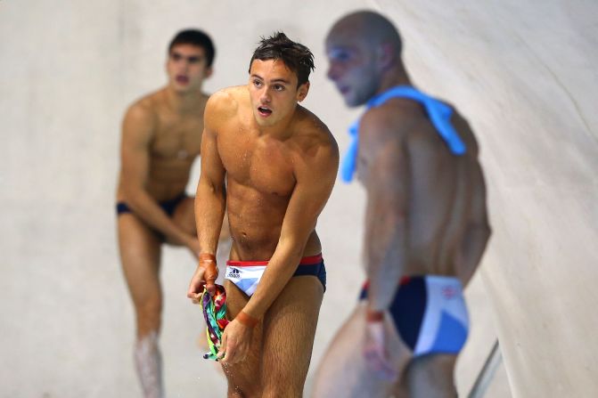 Tom Daley, center, of Great Britain watches from the pool deck during the men's synchronized 10-meter platform diving Monday.