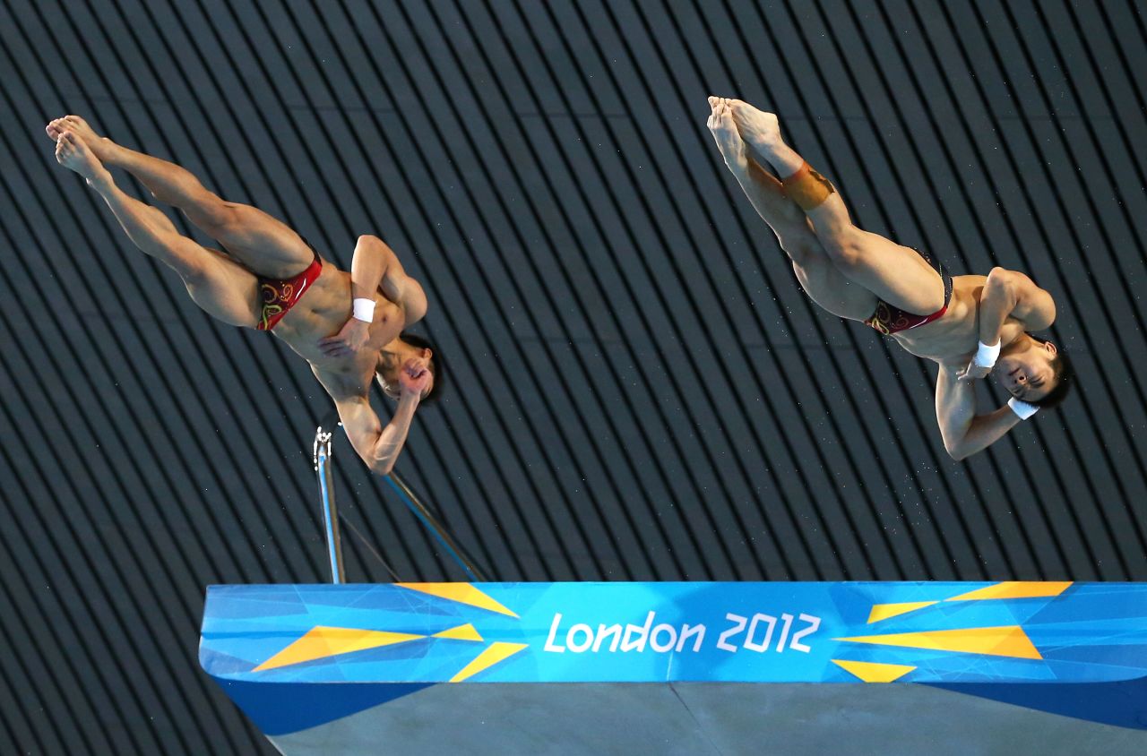 Yuan Cao and Yanquan Zhang of China soar in the men's synchronized 10-meter platform diving on Monday.