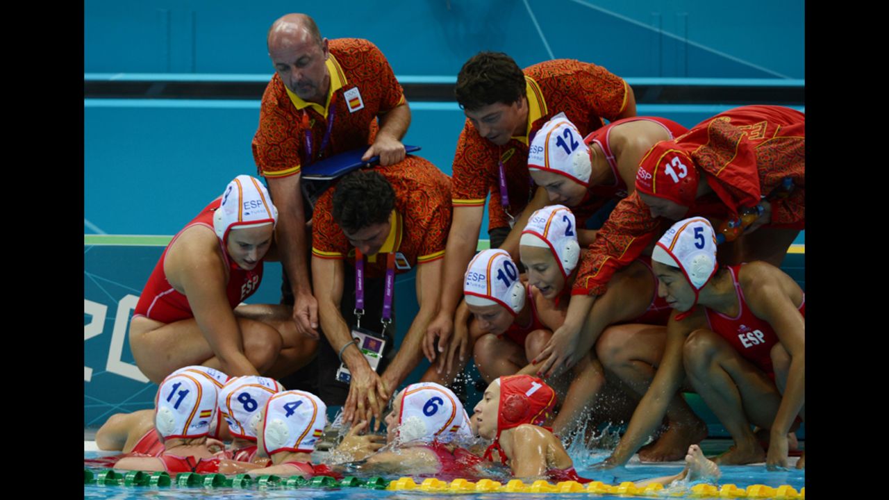 Spain's head coach Miguel Oca Gaia, center, talks to his players during their women's water polo match against China on Monday.