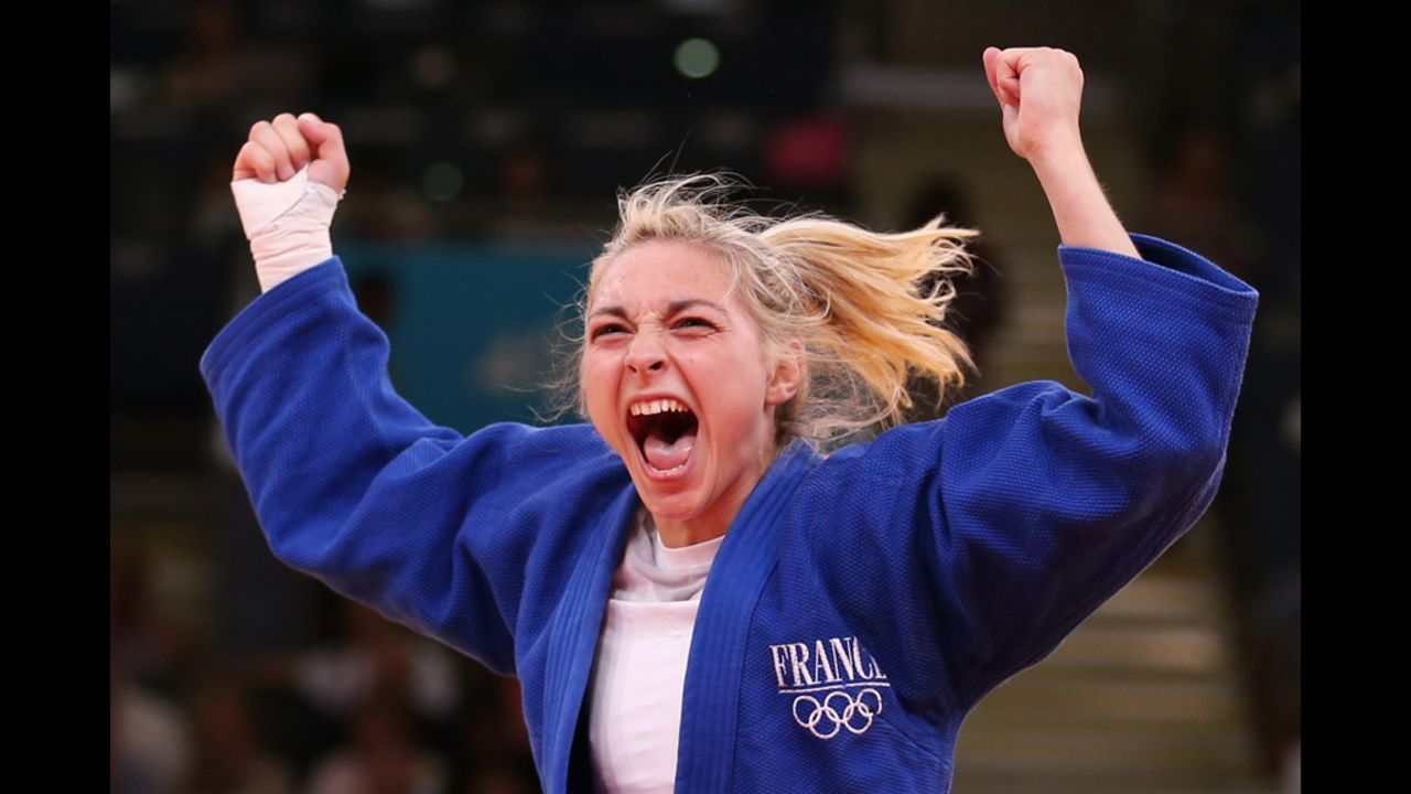 Automne Pavia of France celebrates her bronze medal B over Hedvig Karakas of Hungary during the women's judo on Monday.