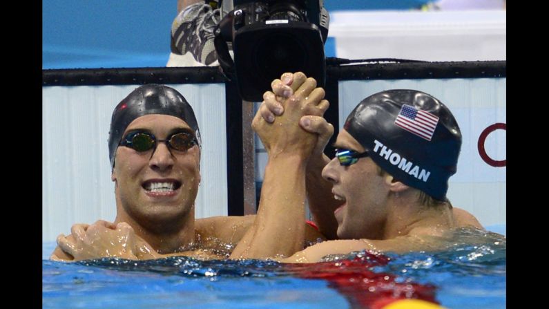 American Matthew Grevers (left) celebrates winning gold with silver medalist and fellow  American Nick Thoman at the finish of the men's 100-meter backstroke final swimming on Monday.