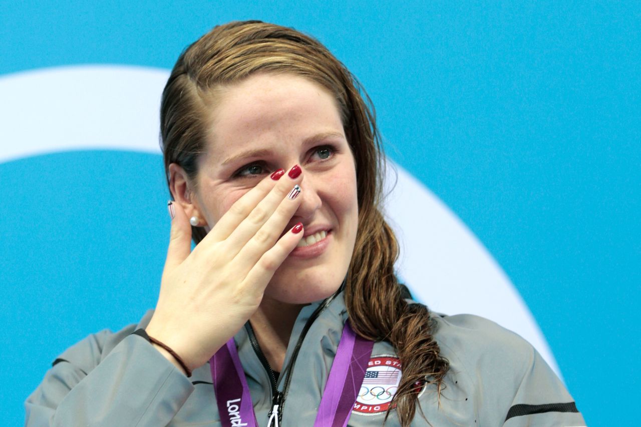 Missy Franklin of the United States wipes a tear as she reacts during the medal ceremony for the women's 100-meter backstroke.