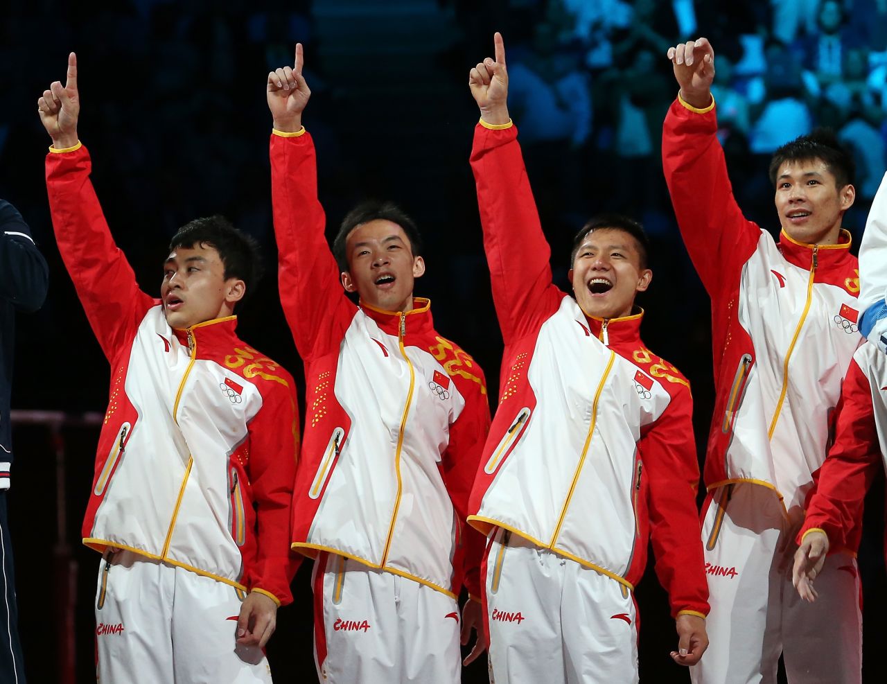 Gold medalists Zhe Feng, Weiyang Guo, Yibing Chen, Chenglong Zhang and Kai Zou of China celebrate on the podium during the medal ceremony in the artistic gymnastics men's team final.