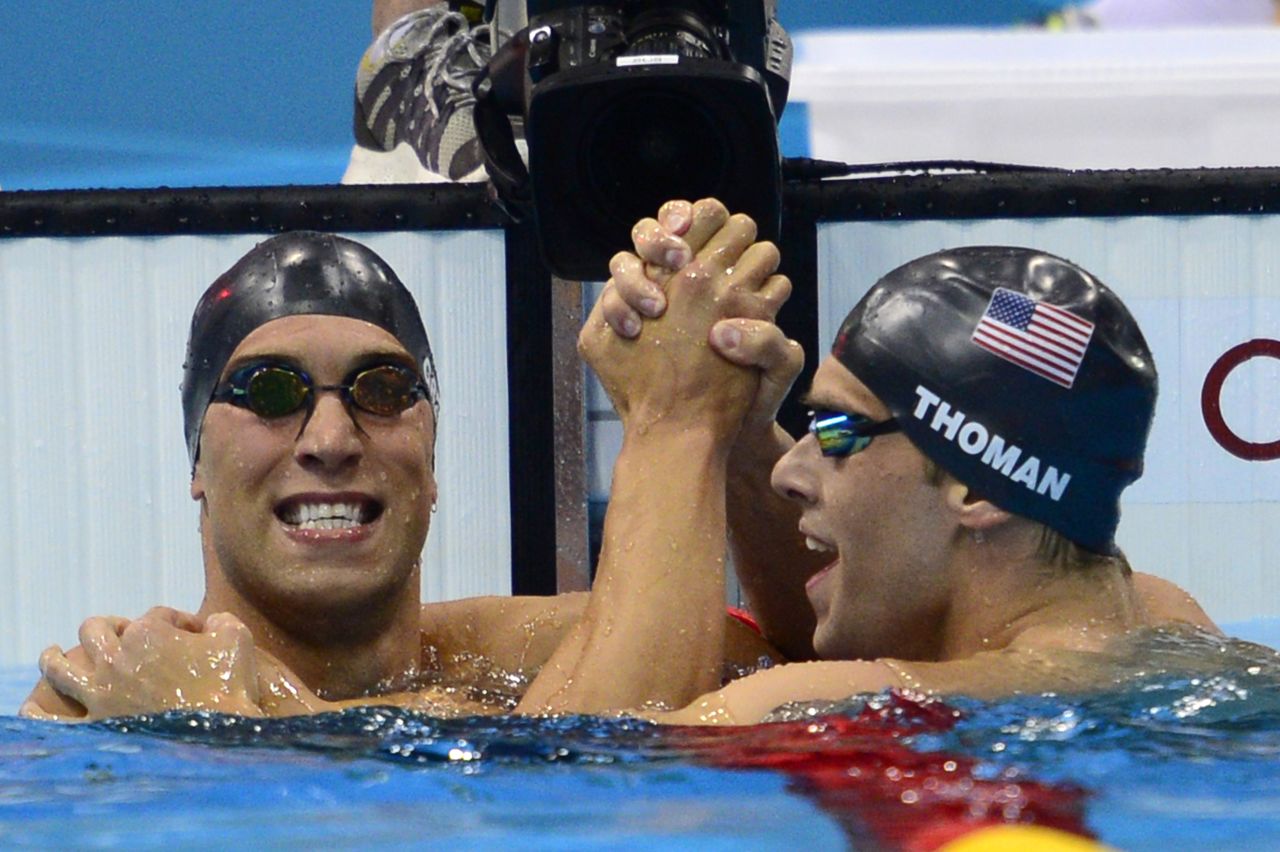U.S. swimmer Matthew Grevers, left,  celebrates winning the gold with silver medalist, U.S. swimmer Nick Thoman, at the finish of the men's 100-meter backstroke final.