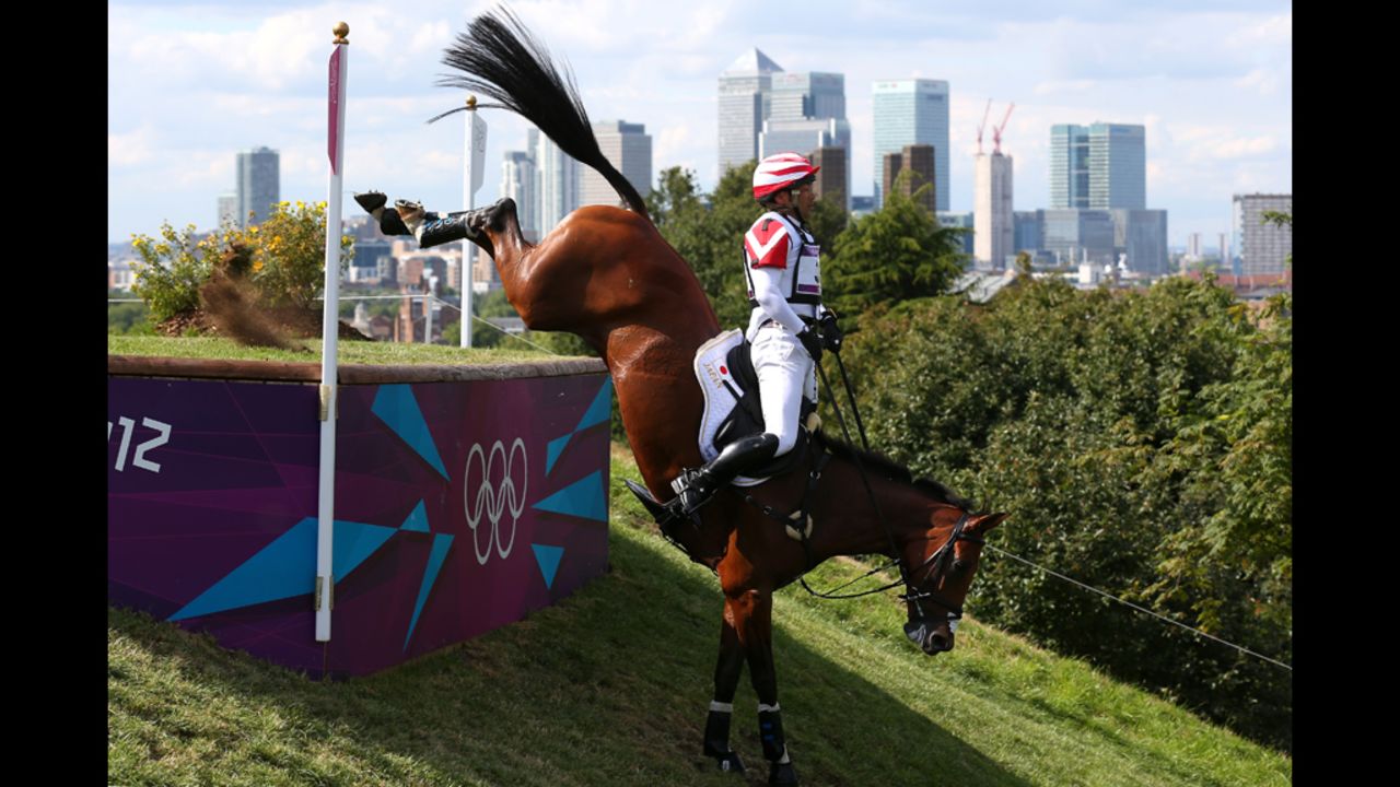 Atsushi Negishi of Japan, riding Pretty Darling, negotiates an obstacle in the eventing cross country equestrian competition.