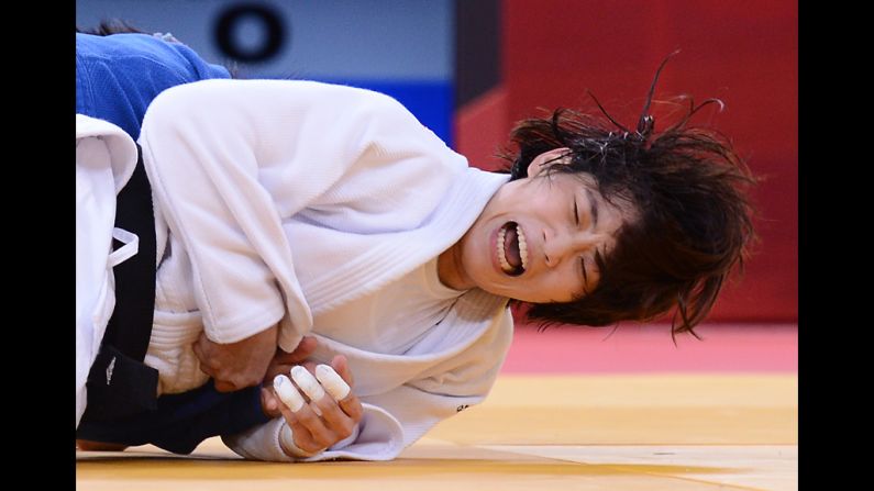 Korea's Jan-Di Kim, in white, takes on Mongolia's Sumiya Dorjsuren during the women's 57-kilogram judo contest on Monday. See <a href="index.php?page=&url=http%3A%2F%2Fwww.cnn.com%2F2012%2F07%2F31%2Fworldsport%2Fgallery%2Folympics-day-four%2Findex.html" target="_blank">day four of the competition</a> from Tuesday, July 31.