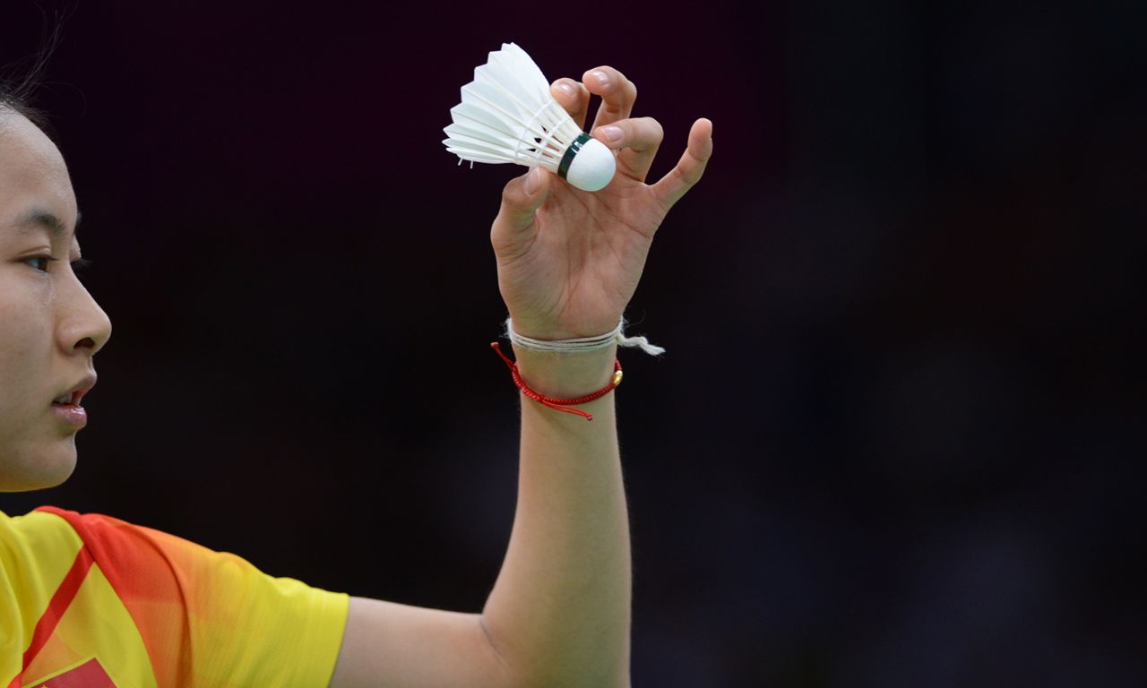 China's No. 1 seed Wang Yihan serves to Michele Li of Canada during the women's singles badminton match against Monday.