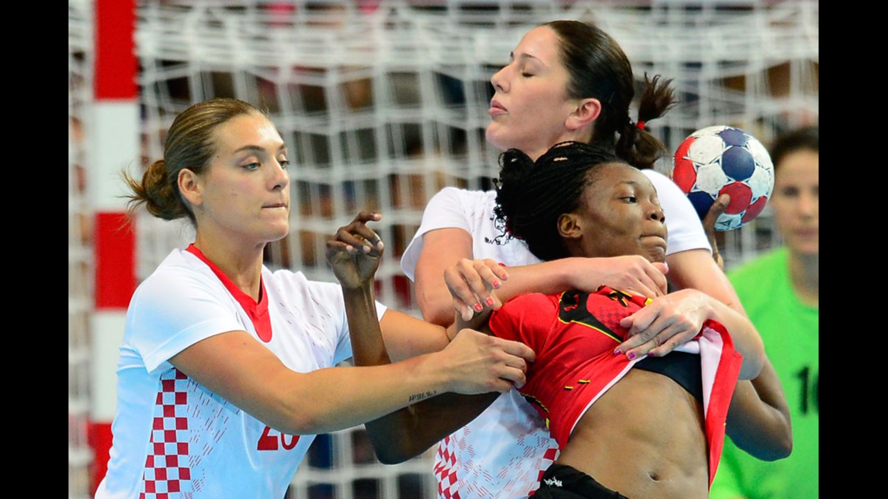 Angola's Isabel Fernandes, right, vies with Croatia's rightback Sonja Basic during the women's handball preliminaries match Monday.