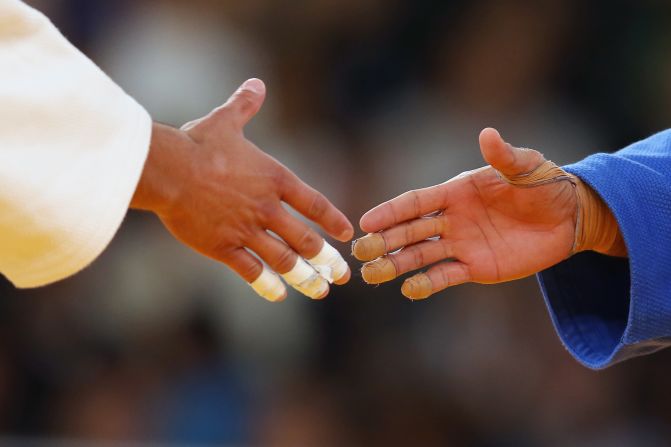Chi Yip Cheung, left, of Hong Kong faces off with Nicholas Delpopolo of the United States in the 73-kilogram judo contest Monday.