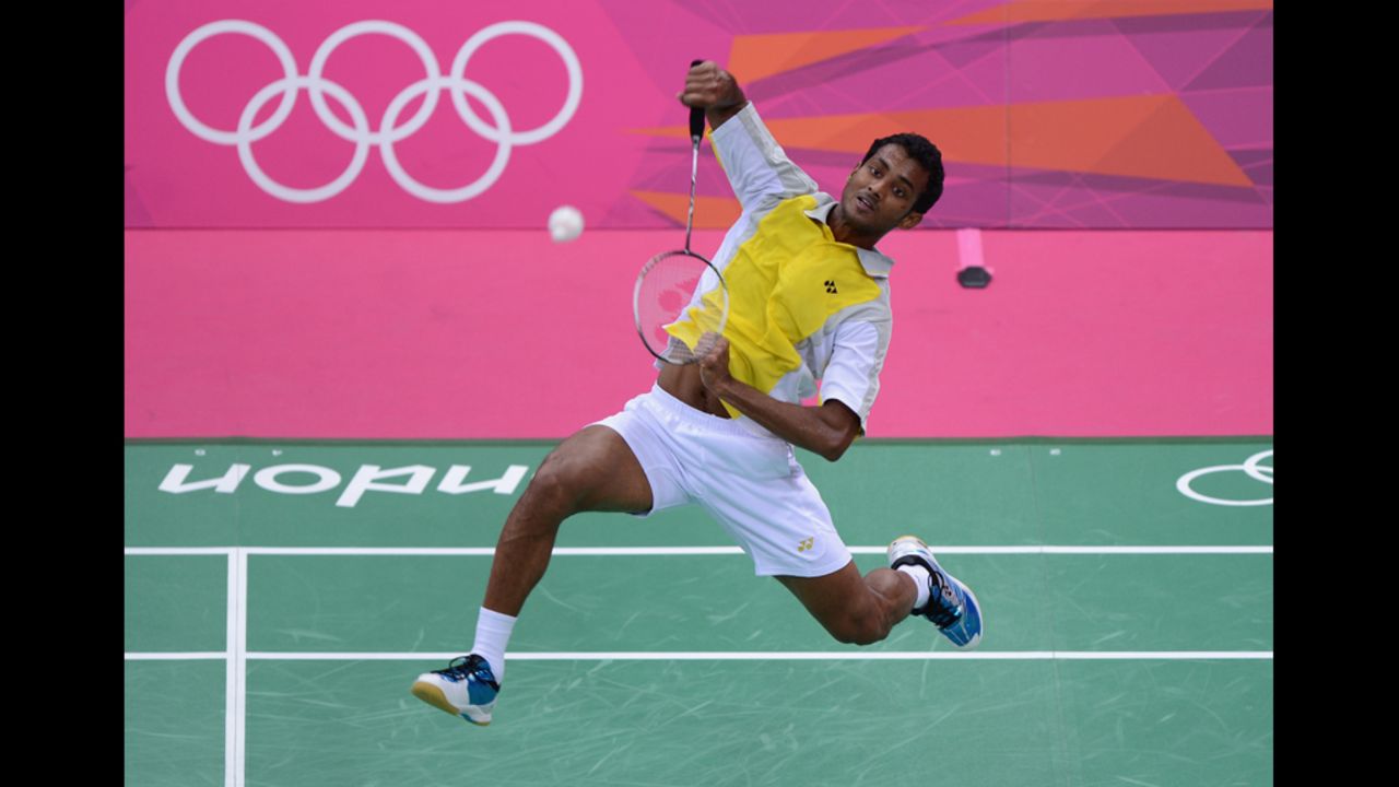 Niluka Karunaratne of Sri Lanka hits a return during his men's singles badminton match on Monday.