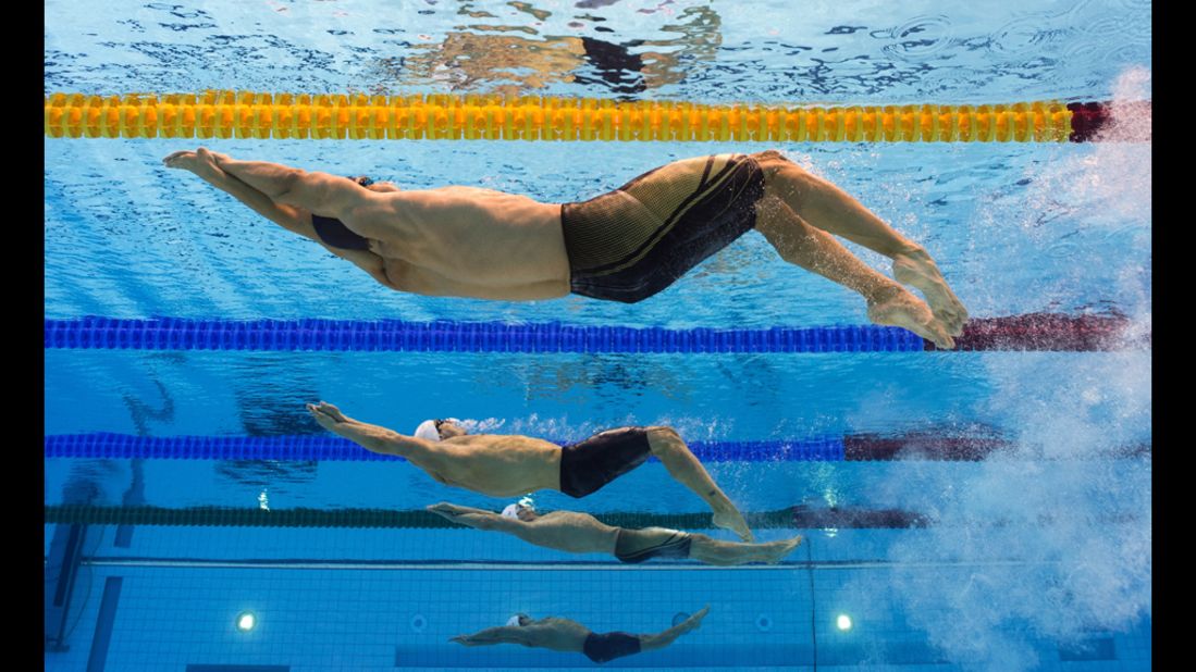 U.S. swimmer Nick Thoman, front, competes in the men's 100-meter backstroke semifinals.