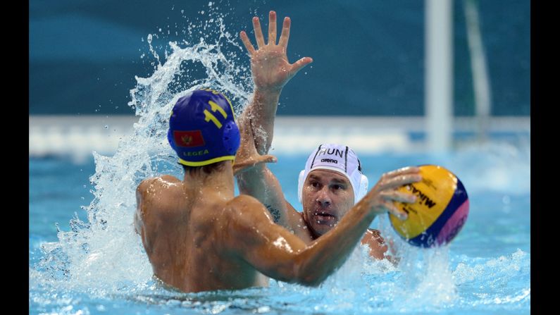 Hungary's Peter Biros, right, challenges Montenegro's Vladimir Gojkovic during the men's water polo preliminary match Tuesday.