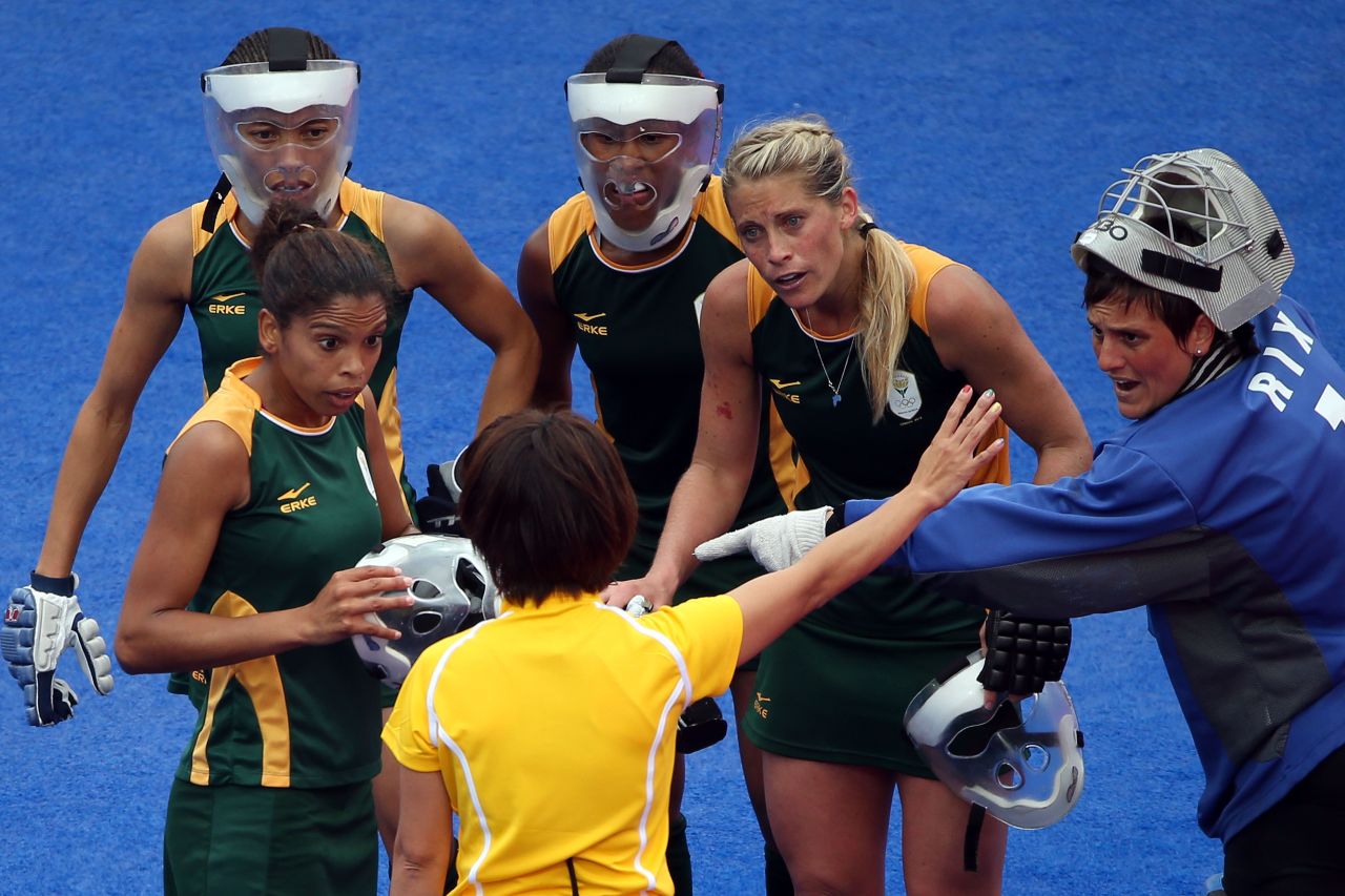 Members of the South African women's field hockey team protest to the referee during a match against New Zealand on Tuesday.