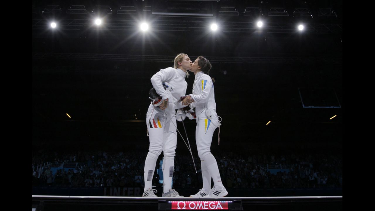 Germany's Britta Heidemann (left) kisses Ukraine's Yana Shemyakina after losing their women's epee gold medal bout as part of the fencing event.