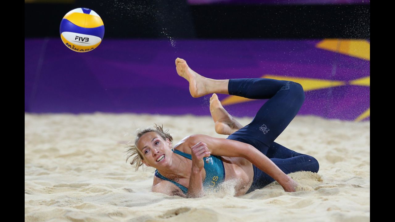 Tamsin Hinchley of Australia dives for a shot during the women's beach volleyball preliminary match between Australia and Austria.