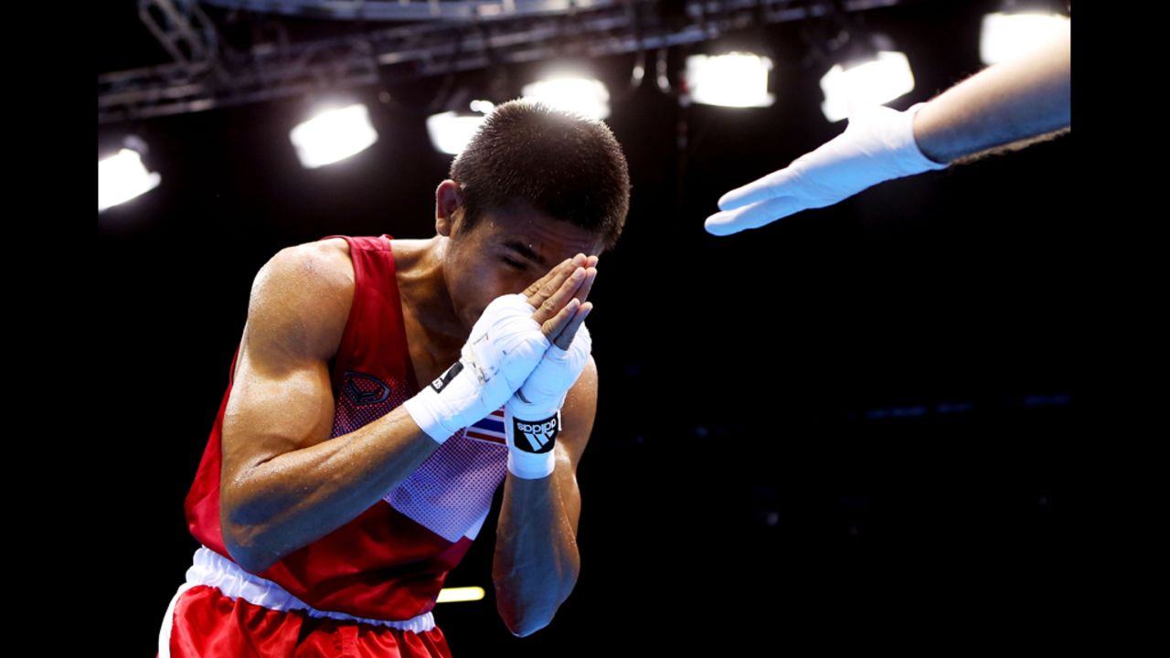 Chatchai Butdee of Thailand celebrates his victory over Selcuk Eker of Turkey during their men's fly boxing match.
