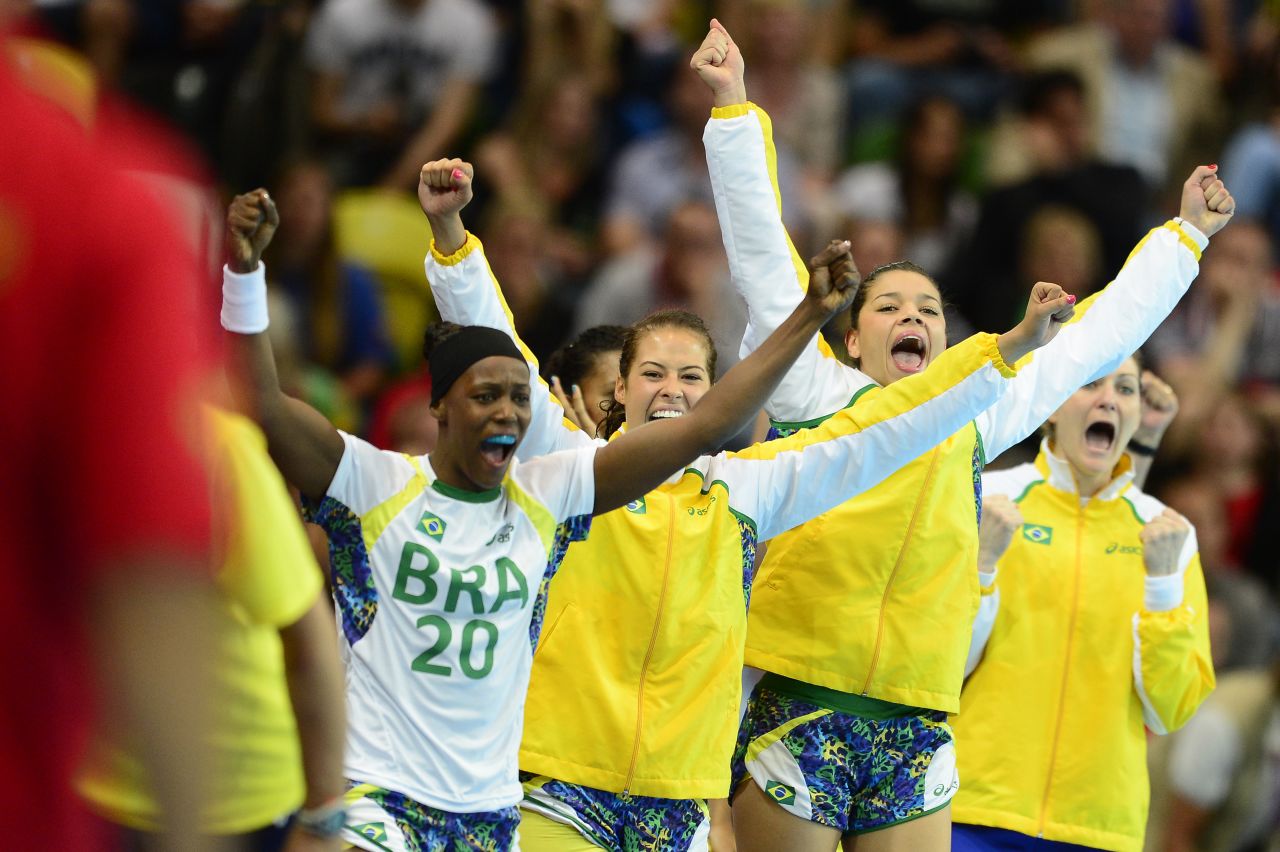 Brazilian players celebrate their victory over Montenegro at the end of the women's preliminaries handball match.
