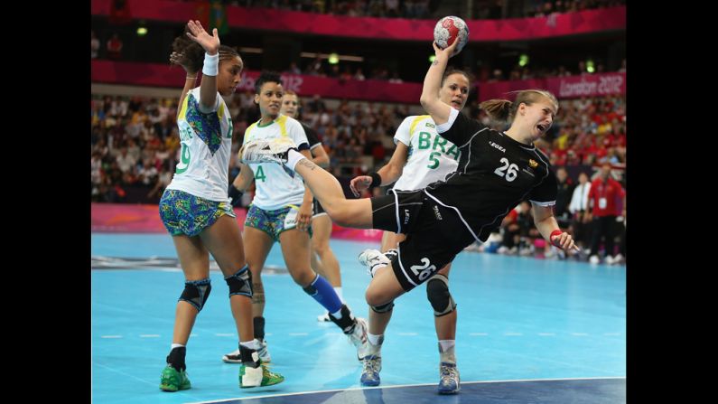 Suzana Lazovic of Montenegro shoots and scores during the women's handball preliminaries.