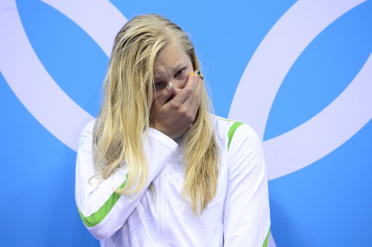 Lithuania's Ruta Meilutyte stands emotional on the podium to receive the the gold medal after winning the women's 100-meter breaststroke swimming event.