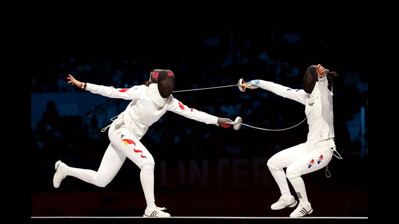 Yujie Sun (left) of China competes against A Lam Shin (right) of Korea during the bronze medal bout in the women's epee individual fencing.