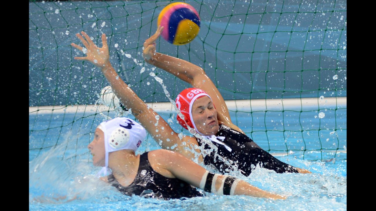 Britain's goalkeeper Rosie Morris, right, attempts to catch a ball hit by Russia during the water polo preliminary match.