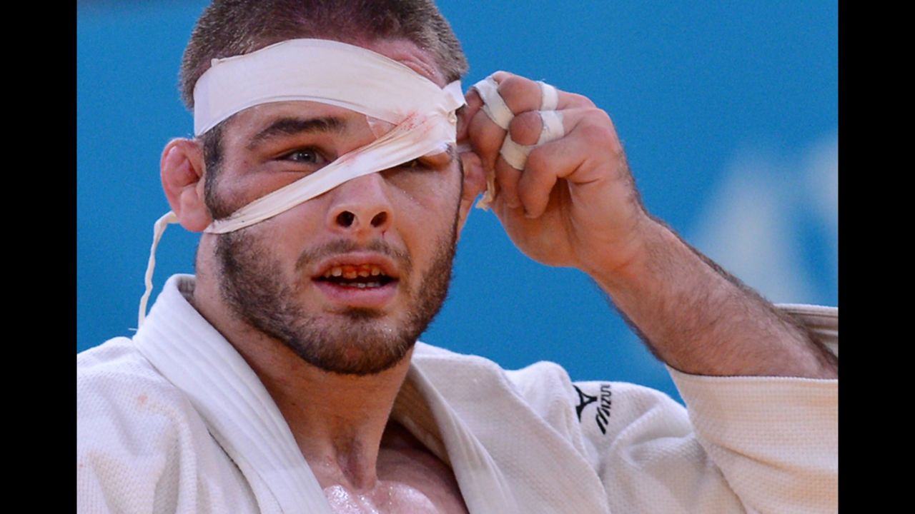 American Travis Stevens adjusts his bandage as he competes Tuesday during the men's under 81-kilogram judo semifinal match.