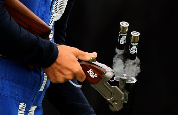 Italy's Ennio Falco removes cartridges as he competes in the men's skeet shooting qualification round Tuesday.