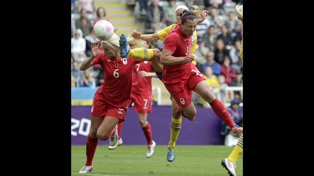 Canada's Melissa Tancredi, right, heads the ball to score her team's second goal against Sweden in Newcastle-upon-Tyne.