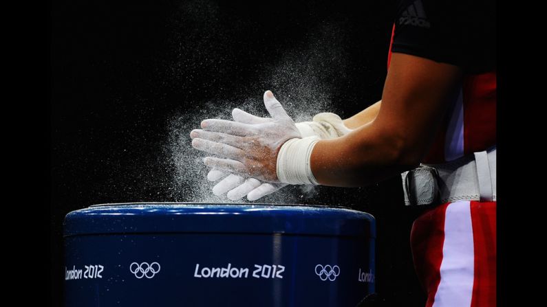 Silvana Saldarriaga of Peru chalks her hands before the women's 63-kilogram weightlifting final.