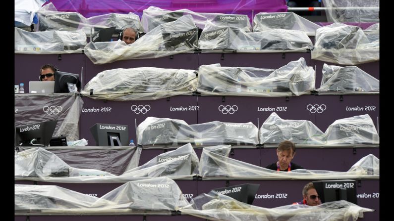 Journalists work from the stands during a women's beach volleyball preliminary match between Spain and Argentina at Centre Court Stadium in London.