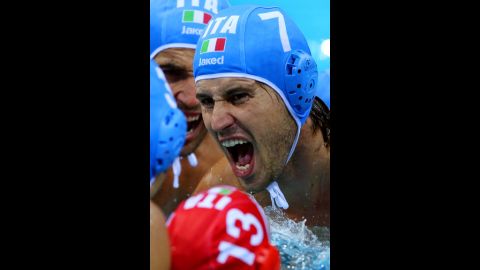 Massimo Giacoppo of Italy motivates his teammates before a water polo match against Greece.