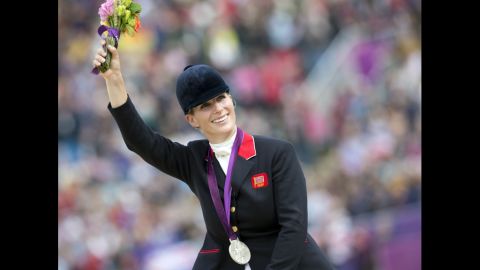 Britain's Zara Phillips waves to the crowd after the British equestrian team won the silver medal in eventing. As part of the British team, Phillips, Queen Elizabeth II's granddaughter, becomes the first member of Britain's royal family to take home an Olympic medal.