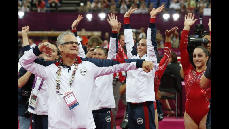 U.S. women's gymnastics coach John Geddert celebrates with his team after they won the gold in the team competition Tuesday.