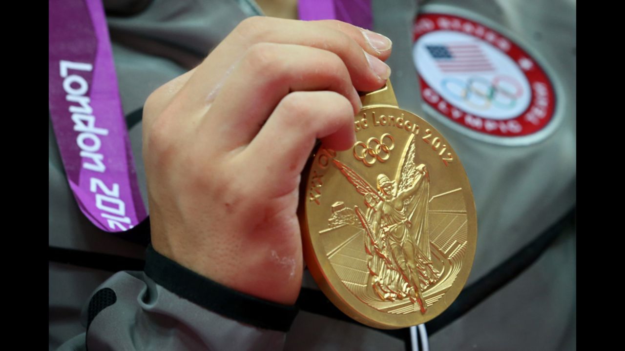 The gold medal hangs from the Olympian's neck.