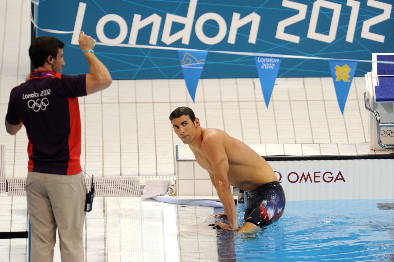 Phelps climbs out of the pool in London after a shock fourth-place finish in the 400-meter medley.
