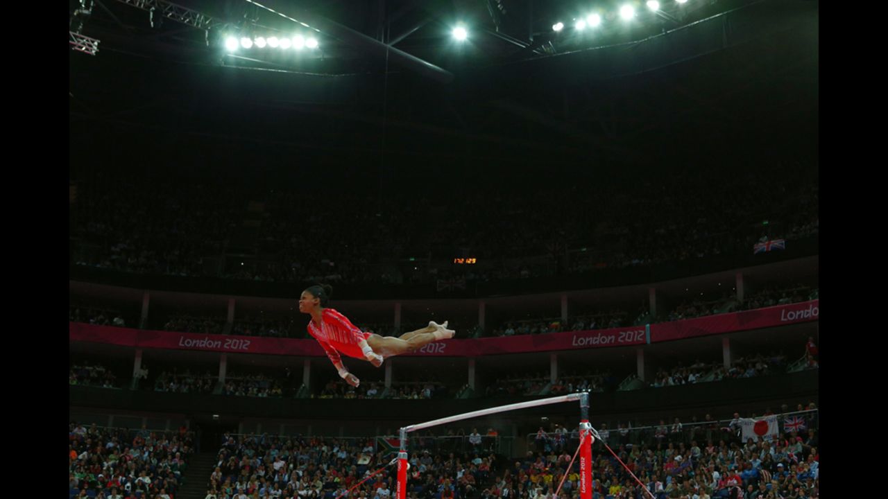 Gabrielle Douglas of the United States competes on the uneven bars in the gymnastics women's team final.