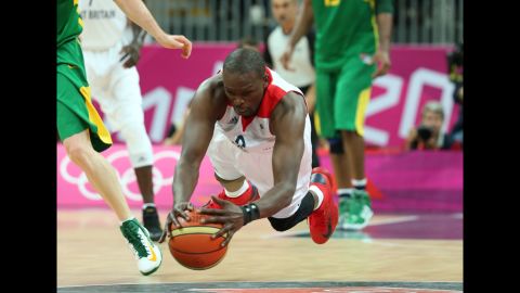 Luol Deng of Great Britain dives for the ball in the men's basketball preliminary match between Great Britain and Brazil.